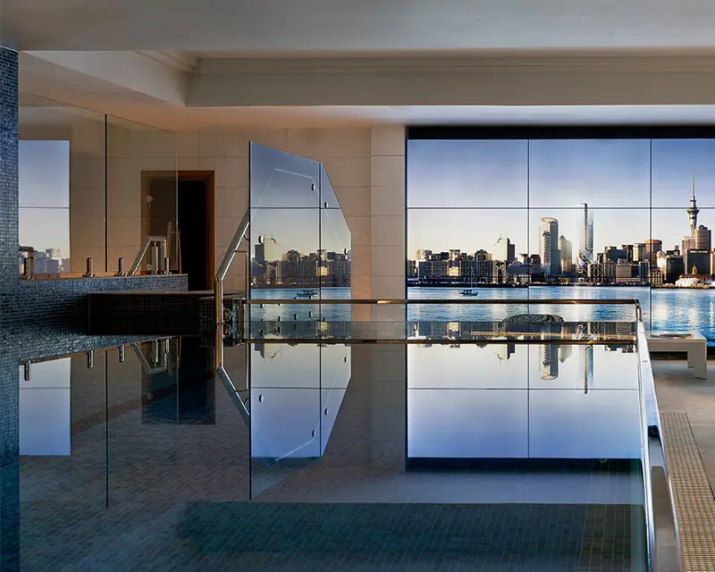 http://A%20large%20pool%20with%20a%20large%20window%20looking%20over%20the%20Auckland%20skyline