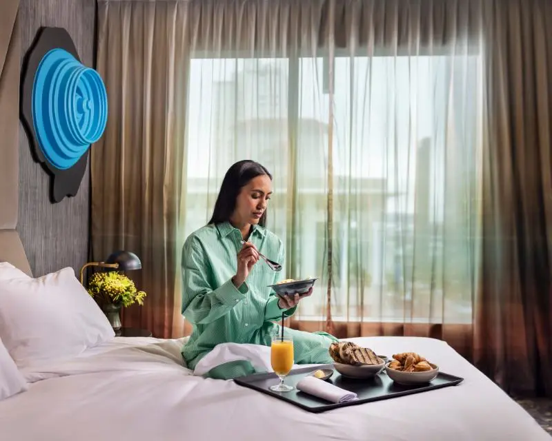 http://Person%20in%20hotel%20room%20having%20breakfast%20in%20bed