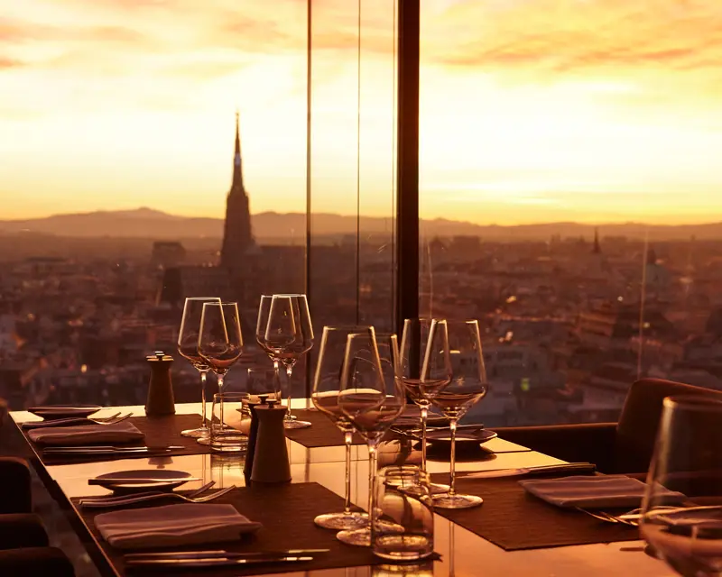 http://Table%20set%20for%20dinner%20in%20front%20of%20view%20of%20city%20at%20dusk