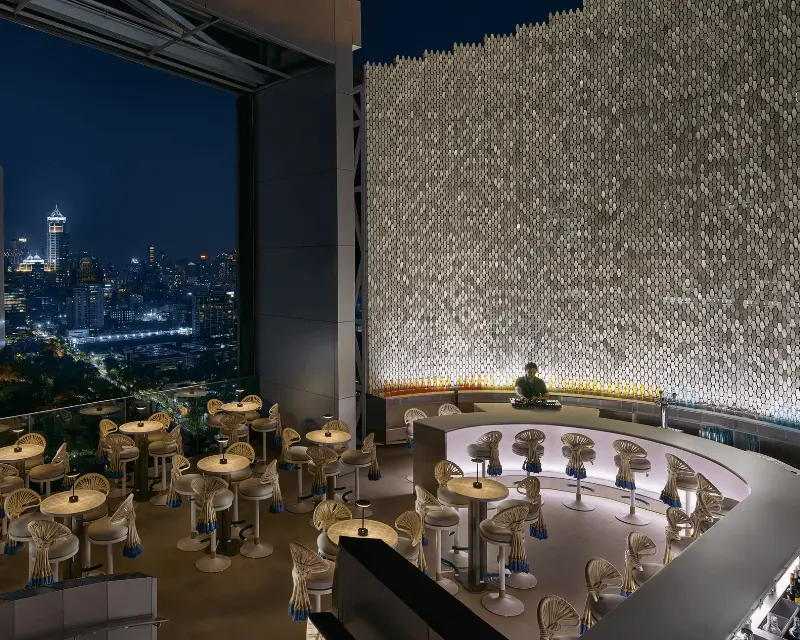 http://Wild%20Iris%20rooftop%20bar%20with%20dramatic%20lighting%20and%20panoramic%20night%20views%20over%20Lumphini%20Park%20and%20the%20Bangkok%20skyline.