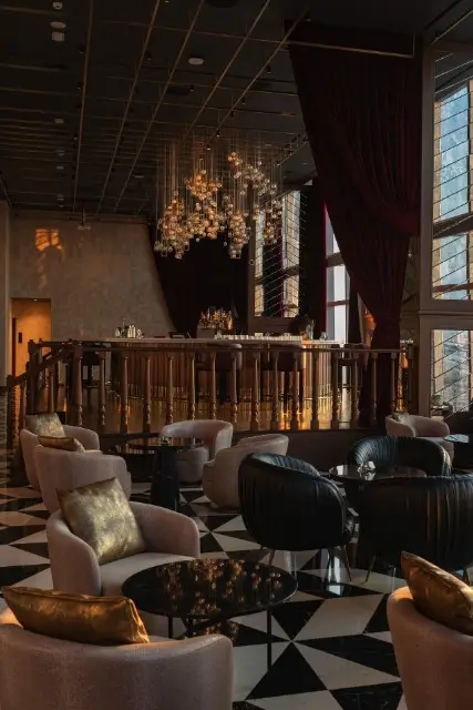 http://Seating%20area%20with%204%20seat%20tables%20and%20cosy%20armchairs.