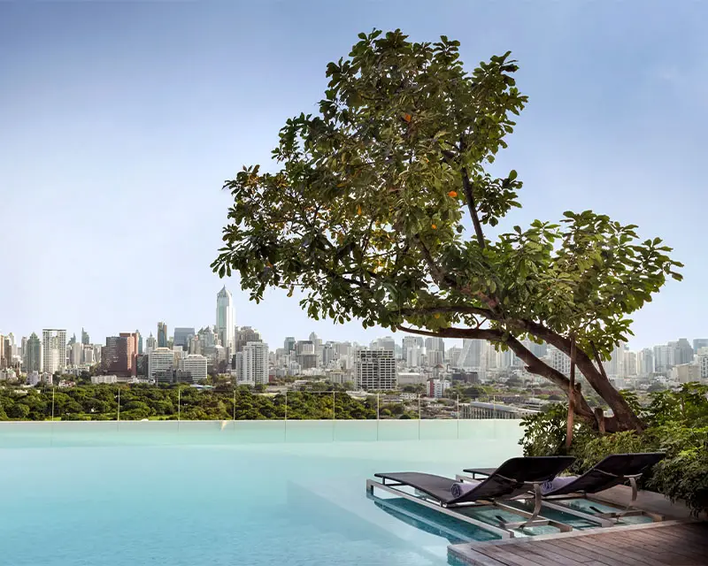 http://A%20large%20infinity%20pool%20looking%20over%20Bangkok's%20skyline.