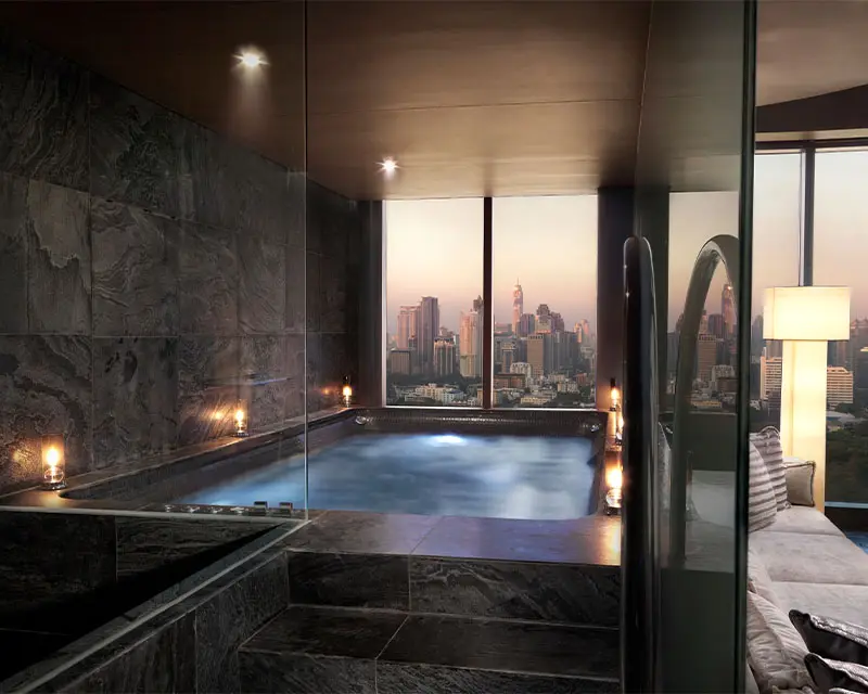 http://Indoor%20whirlpool%20with%20candle%20lighting.%20The%20floor-to-ceiling%20windows%20offer%20a%20view%20of%20Bangkok.